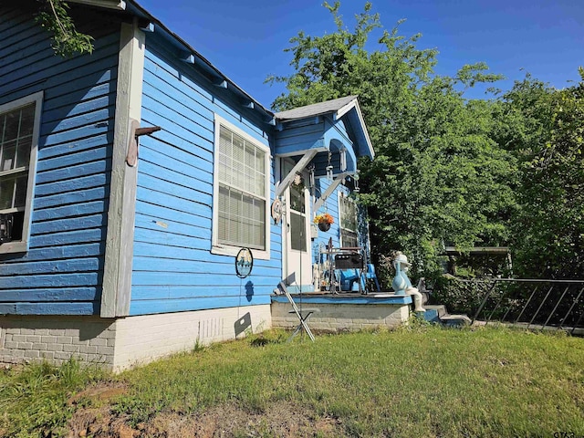 view of property exterior featuring a yard and crawl space