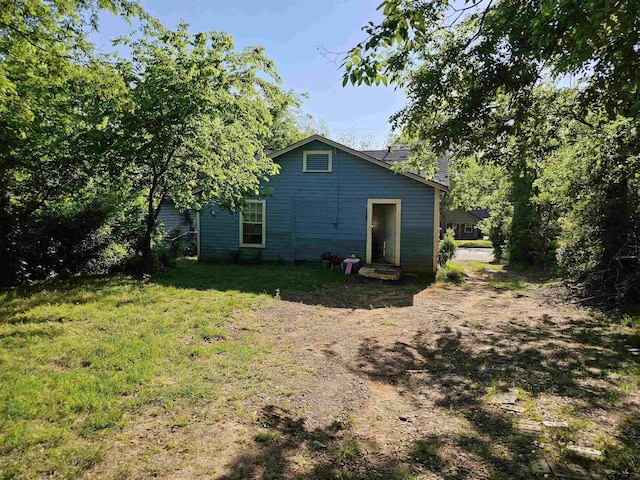 rear view of property with a lawn