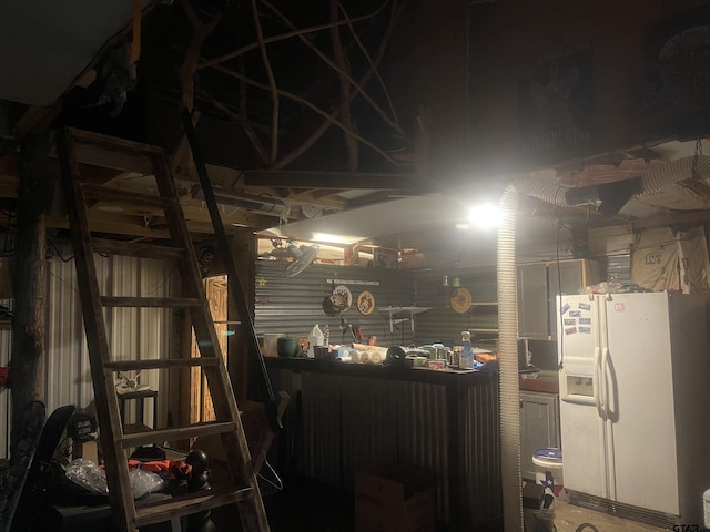 garage with white refrigerator with ice dispenser