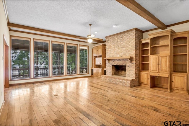 23424BAYSIDE Bay Side Dr, Bullard, TX 75757 - unfurnished living room featuring a textured ceiling, a ceiling fan, light wood-style flooring, a brick fireplace, and ornamental molding