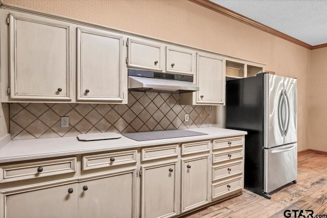 23424BAYSIDE Bay Side Dr, Bullard, TX 75757 - kitchen with freestanding refrigerator, under cabinet range hood, black electric cooktop, ornamental molding, and light wood-style flooring