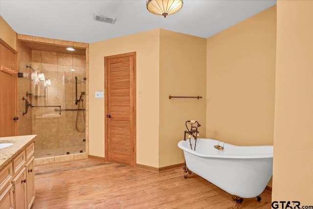 23424BAYSIDE Bay Side Dr, Bullard, TX 75757 - bathroom with a stall shower, wood finished floors, a freestanding tub, vanity, and a closet