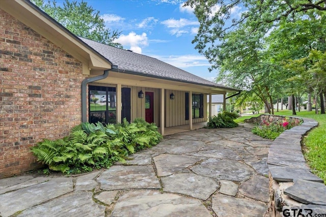 23424BAYSIDE Bay Side Dr, Bullard, TX 75757 - entrance to property with board and batten siding, brick siding, and a shingled roof