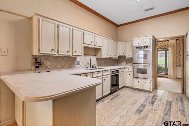 23424BAYSIDE Bay Side Dr, Bullard, TX 75757 - kitchen featuring double oven, black dishwasher, a peninsula, light wood-style flooring, and light countertops