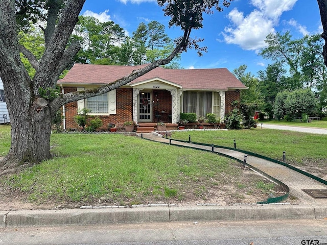ranch-style house featuring brick siding and a front yard