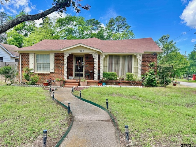 view of front of house with brick siding and a front yard