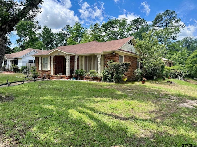single story home with brick siding and a front lawn