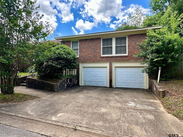 view of front facade featuring concrete driveway, brick siding, and an attached garage