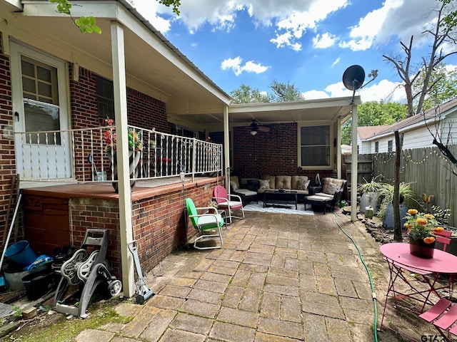 view of patio with ceiling fan, an outdoor living space, and a fenced backyard
