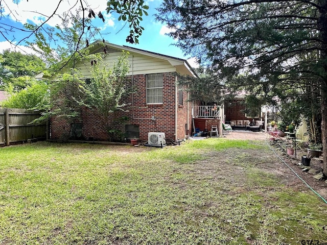 view of property exterior with brick siding and ac unit