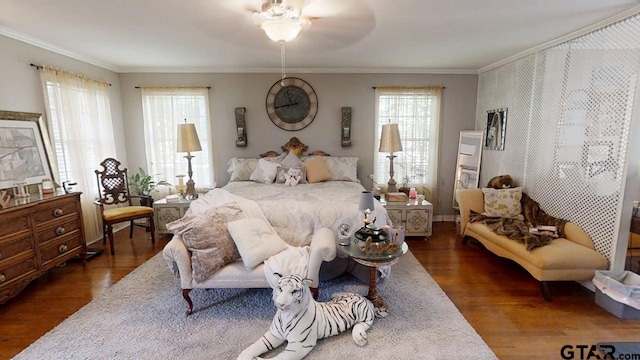 bedroom with dark wood-style floors and crown molding