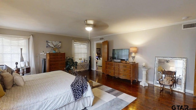 bedroom with wood finished floors, multiple windows, ornamental molding, baseboards, and a ceiling fan