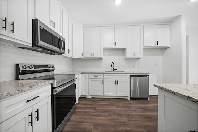 kitchen with white cabinets, dark hardwood / wood-style flooring, sink, and appliances with stainless steel finishes