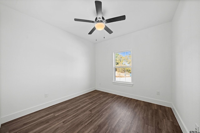 spare room featuring dark hardwood / wood-style flooring and ceiling fan