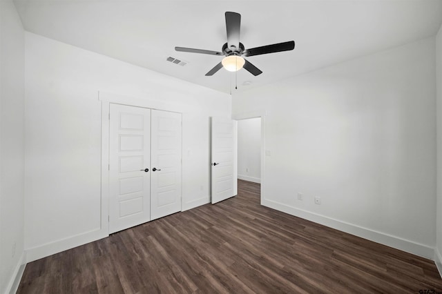 unfurnished bedroom with a closet, ceiling fan, and dark hardwood / wood-style flooring