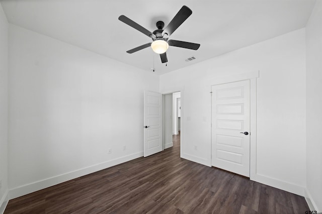 unfurnished bedroom with dark hardwood / wood-style flooring, a closet, and ceiling fan