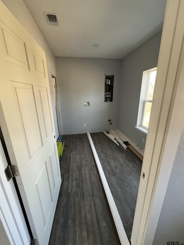 clothes washing area featuring dark hardwood / wood-style flooring