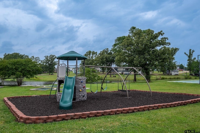 view of play area featuring a water view and a yard