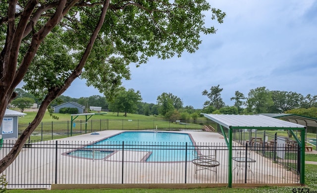 view of swimming pool with a patio area and a lawn