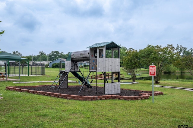 view of play area featuring a water view and a yard