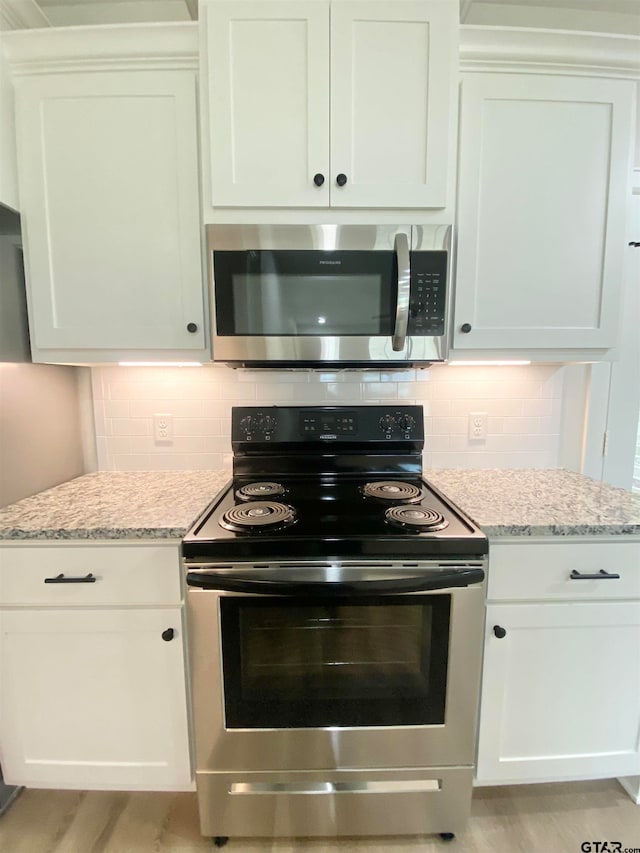 kitchen featuring white cabinetry and appliances with stainless steel finishes