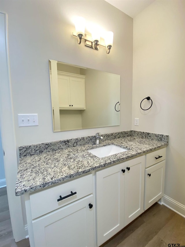 bathroom featuring hardwood / wood-style floors and vanity