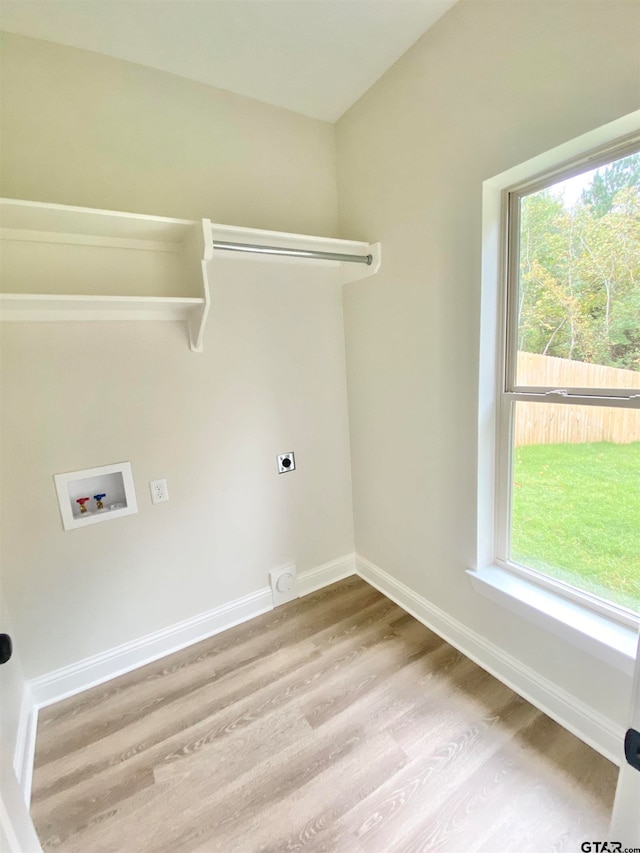 laundry room featuring washer hookup, hookup for an electric dryer, and light hardwood / wood-style flooring