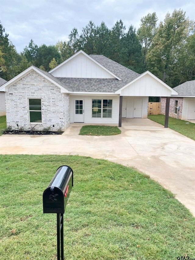 ranch-style home featuring a front yard and a carport