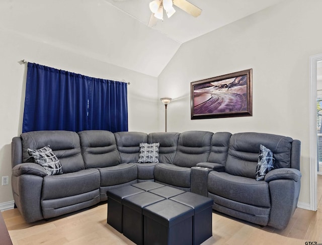 living room with ceiling fan, light wood-type flooring, and vaulted ceiling