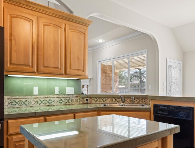 kitchen featuring tile counters, sink, black dishwasher, backsplash, and vaulted ceiling