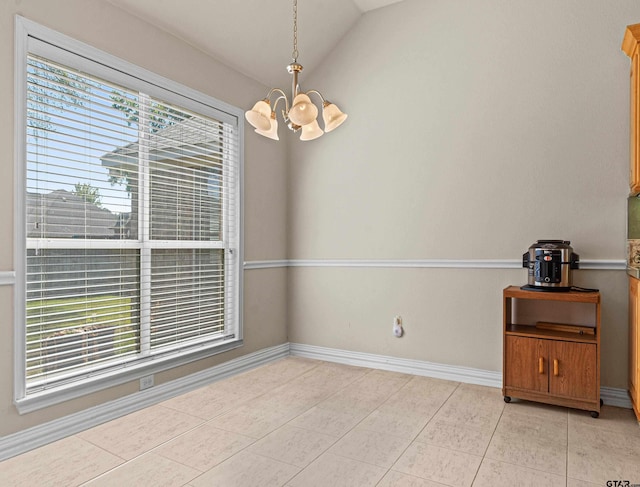 spare room featuring light tile patterned floors, vaulted ceiling, and an inviting chandelier