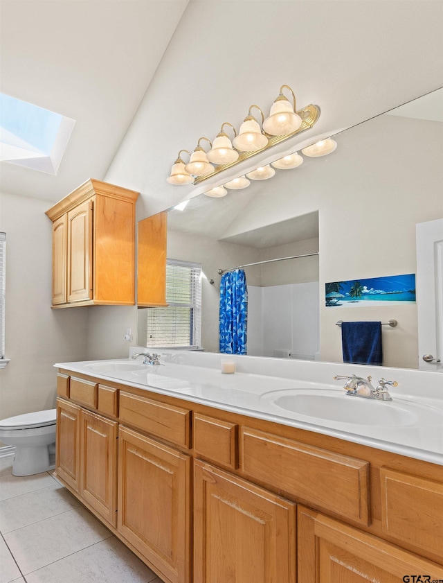 bathroom featuring vanity, lofted ceiling with skylight, tile patterned floors, toilet, and curtained shower