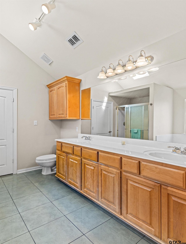 bathroom featuring vanity, tile patterned floors, walk in shower, and vaulted ceiling