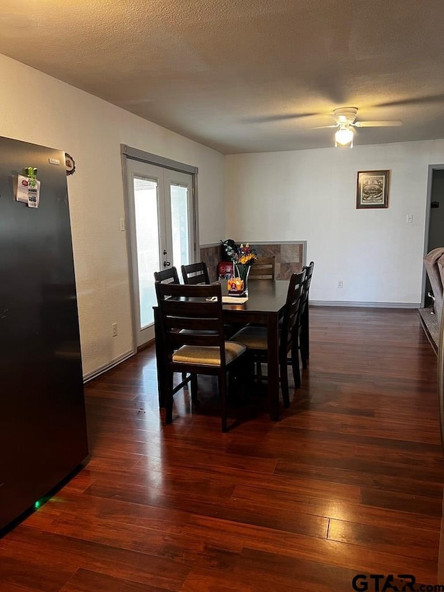 dining room featuring ceiling fan, dark hardwood / wood-style floors, a textured ceiling, and french doors