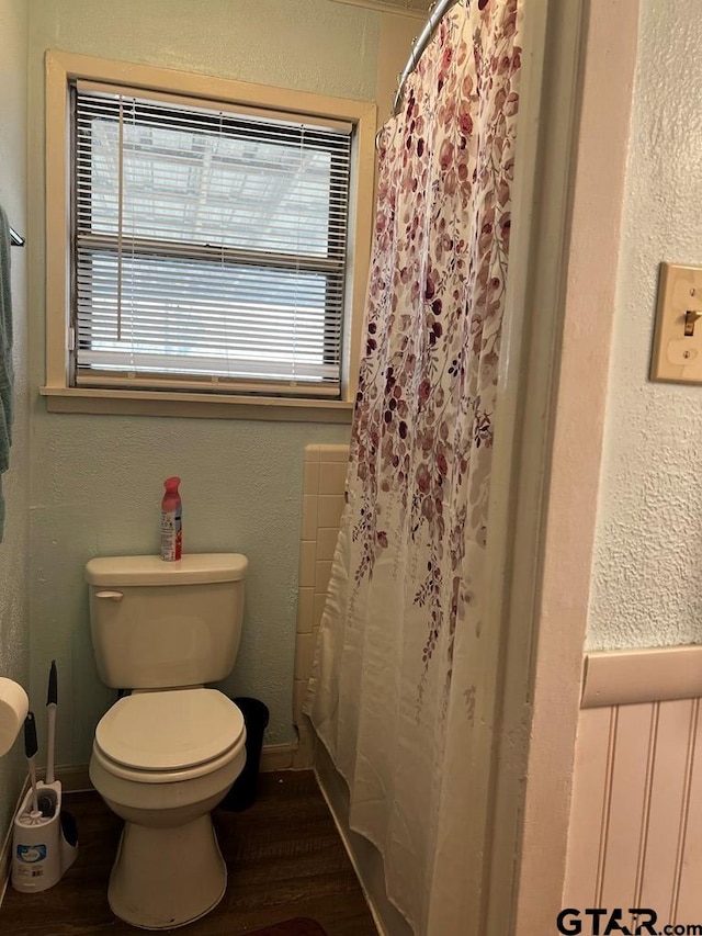 bathroom featuring wood-type flooring and toilet