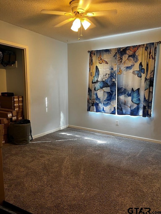 unfurnished room featuring ceiling fan, a textured ceiling, and carpet