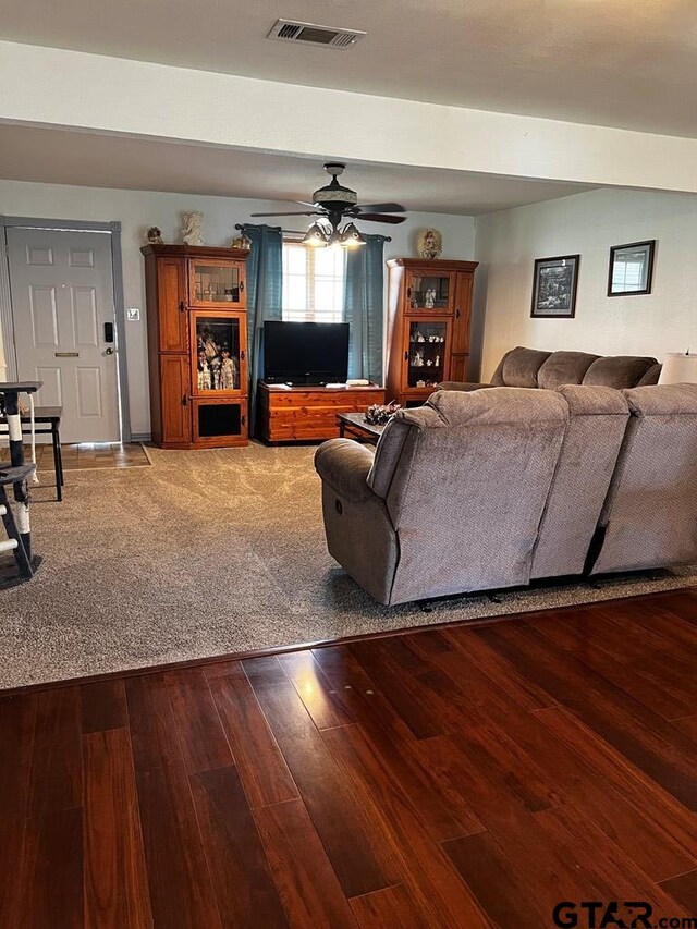 living room featuring hardwood / wood-style floors and ceiling fan