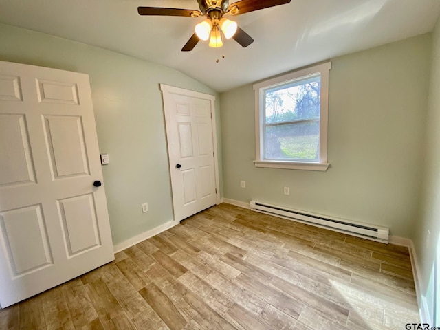 unfurnished bedroom with lofted ceiling, light hardwood / wood-style flooring, ceiling fan, and baseboard heating