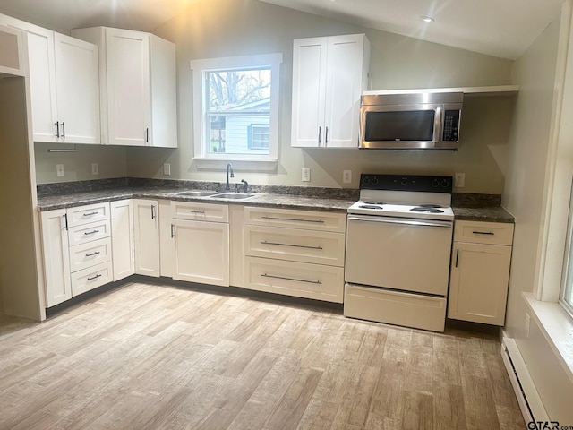 kitchen with electric stove, white cabinets, sink, and a baseboard heating unit