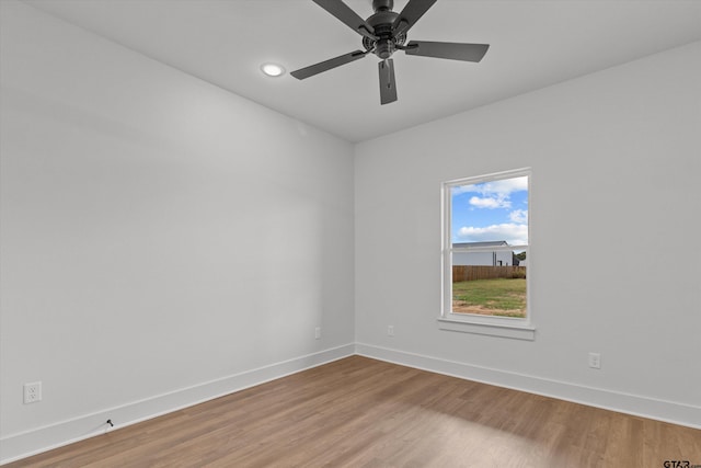 spare room with wood-type flooring and ceiling fan