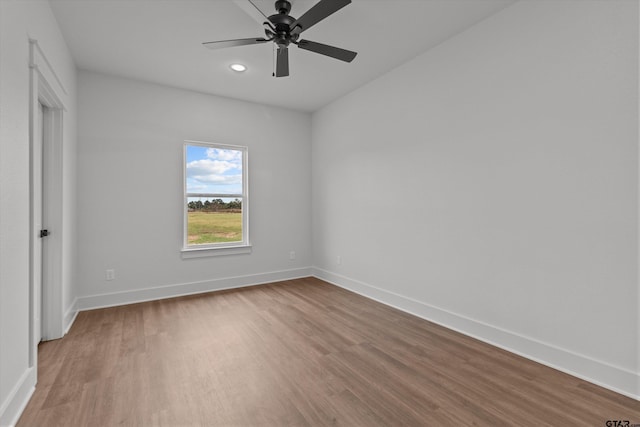 spare room featuring hardwood / wood-style floors and ceiling fan