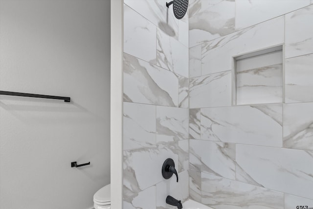 bathroom with toilet and tiled shower / bath combo