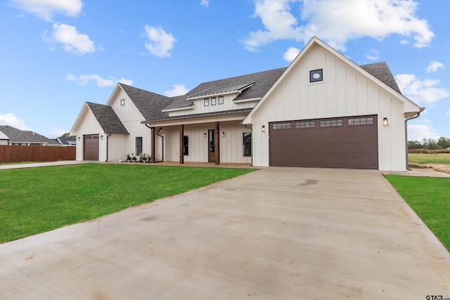 modern farmhouse style home with covered porch, a garage, and a front yard