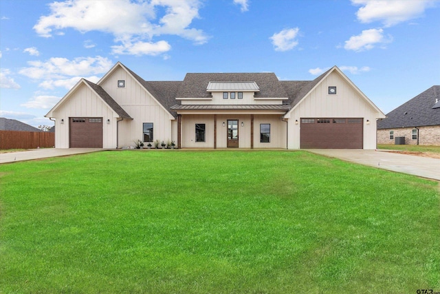 modern farmhouse style home featuring a front yard, covered porch, and a garage