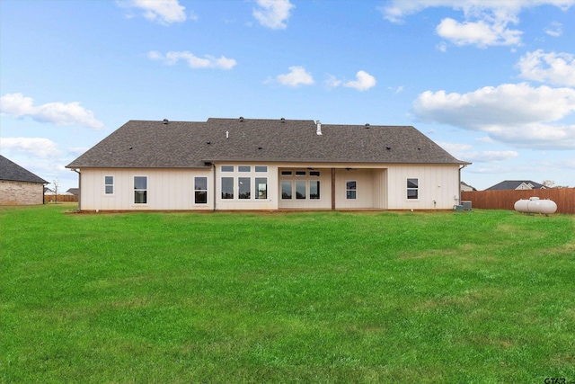 rear view of property with a lawn