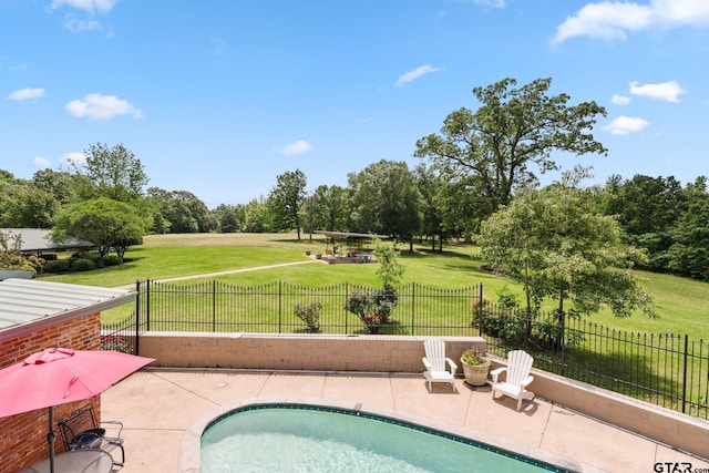 view of swimming pool with a patio area and a yard