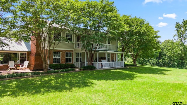 exterior space with a balcony and a yard