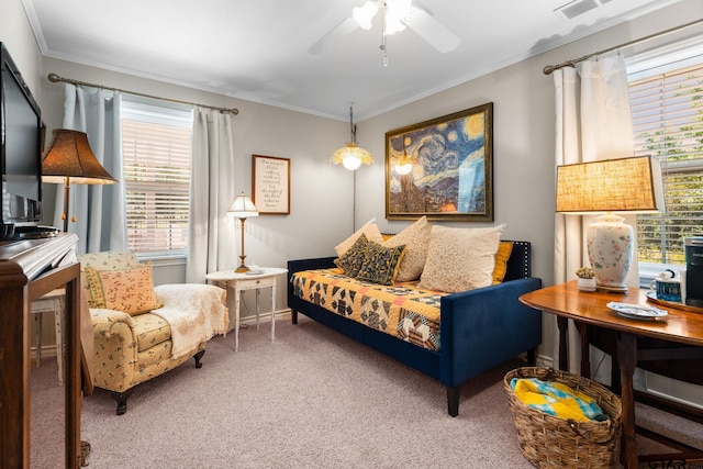 sitting room with ornamental molding, carpet flooring, and ceiling fan