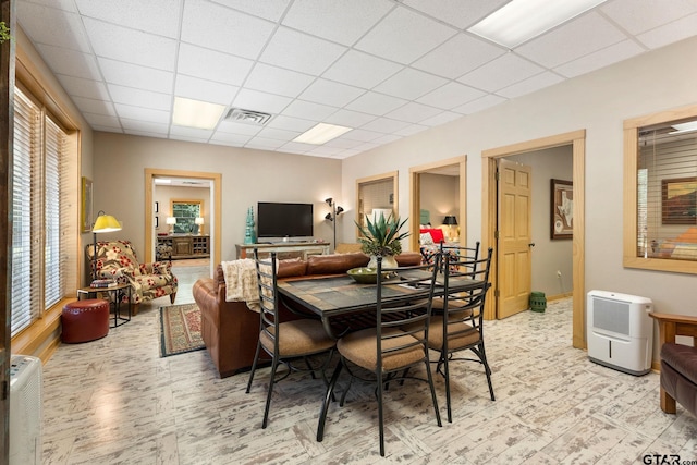 dining area with a drop ceiling