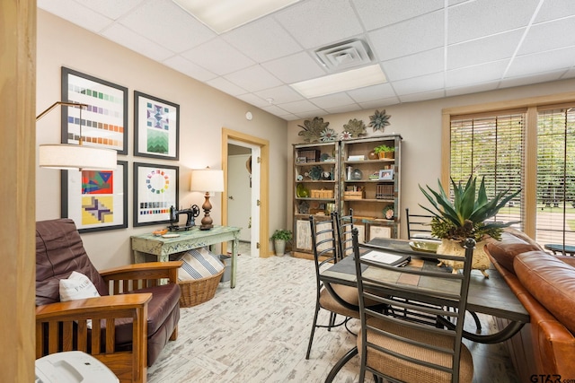 office featuring wood-type flooring and a paneled ceiling